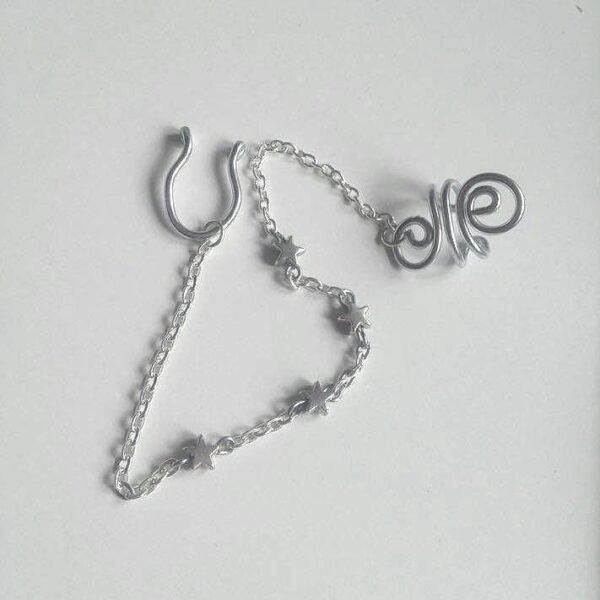 Handmade Star Septum Nose to Ear Chain with silver metallic star beads - Body Jewelry - No piercing nose required (fake nose ring)- Ring Adaptable, Fake septum, you can wear it without a nose piercing - The chain is approximately 13cm long and is only 3mm wide, which is so tiny - Hoop Nose Made from 16 gauge aluminium wire non-tarnish and antiallergenic - Each piece is created by hand, giving it a unique charm. ***************************************************************************************** Each piece is handcrafted using thick, anodized aluminium wire. Important Note: To keep the ring in perfect condition is important to know how to open and close our ring properly; look for the opening of the ring and place the fingers of each hand on each side of the opening and make a sideways movement with each hand in a reverse direction
